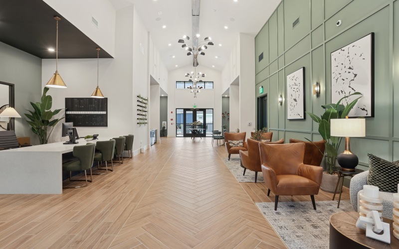 a leasing office with couches, chairs and tables