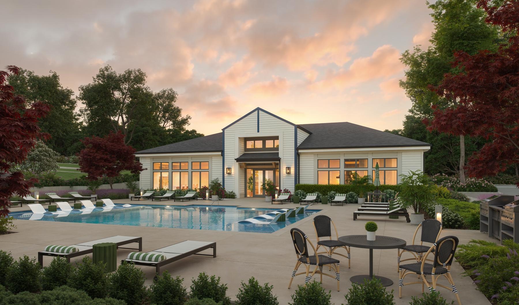 a building with a pool and chairs
